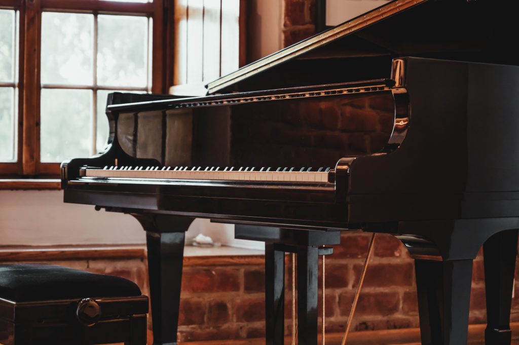 grand piano in a rustic room